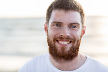 Image showing face of happy smiling young man on beach