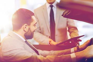 Image showing happy man with car dealer in auto show or salon