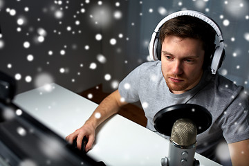 Image showing man in headset playing computer video game at home