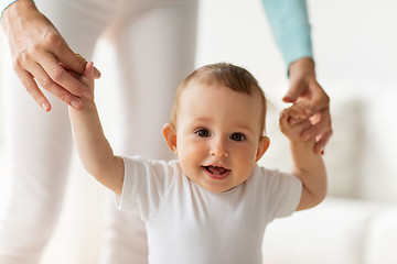 Image showing happy baby learning to walk with mother help