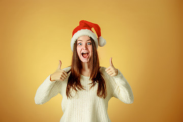 Image showing Surprised christmas girl wearing a santa hat