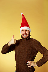 Image showing Smiling christmas man wearing a santa hat
