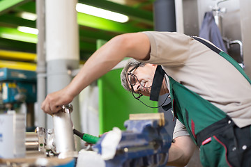 Image showing Industrial worker welding in metal factory.