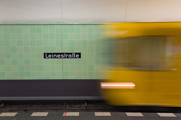 Image showing Yellow subway train in motion on Berlin Alexanderplatz underground station.