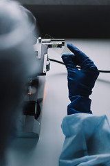 Image showing Crop hands putting microscope glasses in box