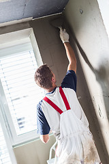 Image showing Plasterer renovating indoor walls and ceilings.