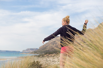 Image showing Free Happy Woman Enjoying Last Autumn Sun on Vacations.