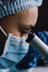 Image showing Female scientist looking at microscope