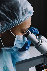 Image showing Female scientist looking at microscope