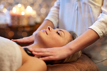 Image showing close up of woman having hot stone massage in spa