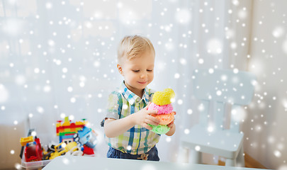 Image showing happy little baby boy with ball clay at home