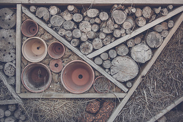 Image showing Wood on a shelf in a woodshed