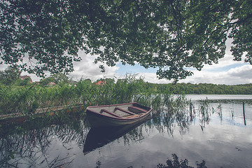 Image showing Small boat among green reeds