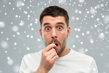 Image showing man with tweezers tweezing hair from nose