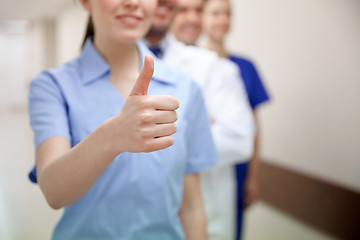 Image showing close up of doctors at hospital showing thumbs