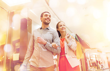 Image showing happy young couple with shopping bags in mall