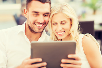 Image showing happy couple with tablet pc at restaurant lounge