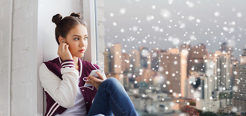 Image showing teenage girl with smartphone and earphones