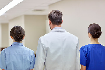 Image showing group of medics or doctors walking along hospital