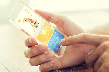 Image showing close up of hand with sport app on smartphone