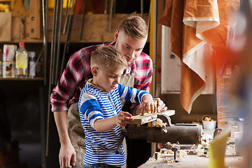 Image showing father and son with ruler measure wood at workshop