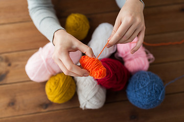 Image showing woman pulling yarn up into ball