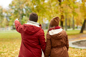 Image showing happy young couple walking in autumn park