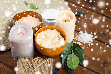 Image showing natural body scrub and candles on wood