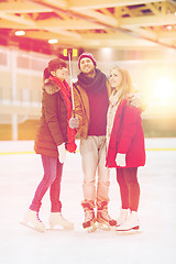 Image showing happy friends taking selfie on skating rink