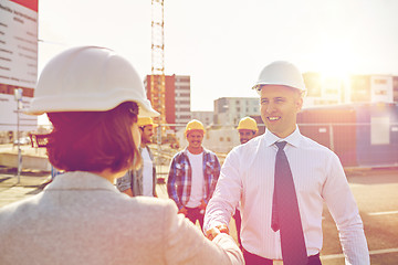 Image showing builders making handshake on construction site
