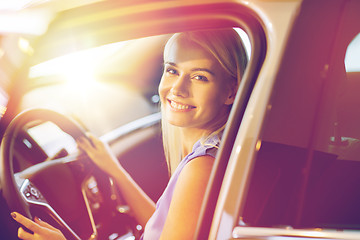 Image showing happy woman inside car in auto show or salon