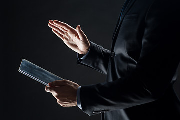 Image showing close up of businessman with transparent tablet pc