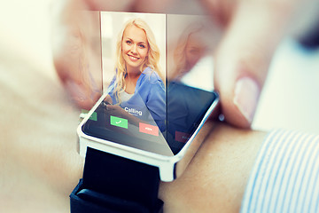 Image showing close up of hand with incoming call on smart watch