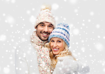 Image showing smiling couple in winter clothes hugging