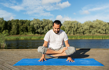 Image showing man making yoga in scale pose outdoors