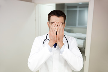 Image showing sad or crying male doctor at hospital ward