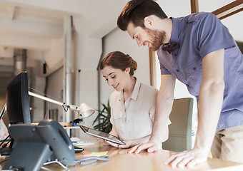 Image showing happy creative team with tablet pc in office