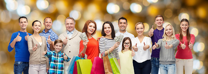 Image showing happy people with shopping bags and money