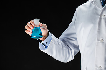 Image showing close up of scientist holding flask with chemical