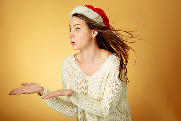 Image showing Surprised christmas girl wearing a santa hat