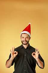 Image showing Smiling christmas man wearing a santa hat