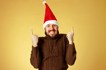 Image showing Surprised christmas man wearing a santa hat