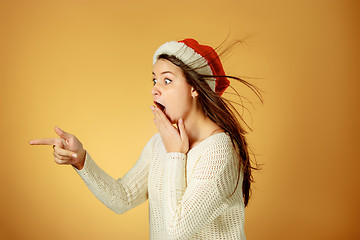 Image showing Surprised christmas girl wearing a santa hat