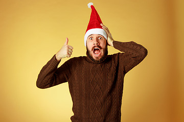 Image showing Smiling christmas man wearing a santa hat