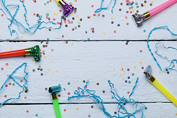 Image showing Whistles, confetti on wooden background