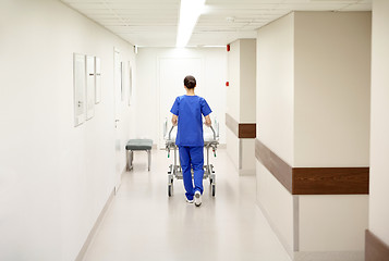 Image showing nurse carrying hospital gurney to emergency room