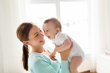 Image showing happy young mother with little baby at home