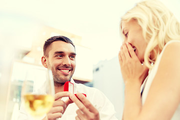 Image showing man with engagement ring making proposal to woman