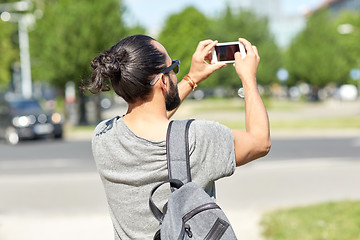 Image showing hipster man taking picture on smartphone