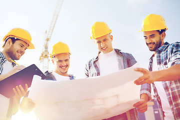 Image showing group of builders with tablet pc and blueprint